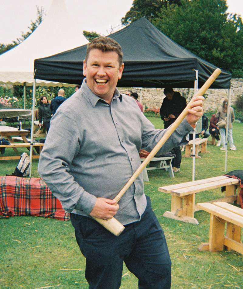 Storm employee playing guitar with a croquet mallet